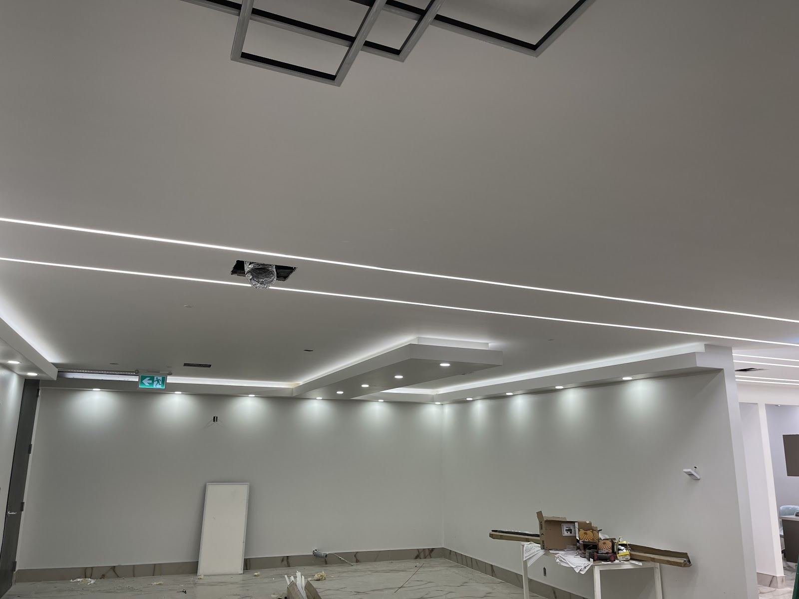 A commercial space with linear LED lighting set into the ceiling
